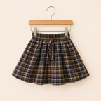 Forest green tartan gathered skirt for girls with cream and burgundy checks hanging on a wooden hanger